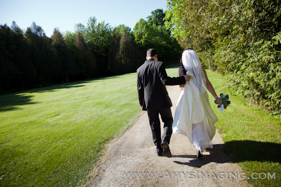 Scenic shot of bride and groom walking holding hands