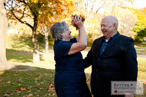 Portrait of Older Couple having Fun in the Fall Leaves